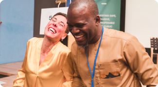 Two people smiling at DPGA conference with name badges