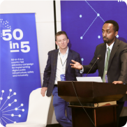 Two people smiling at DPGA conference with name badges